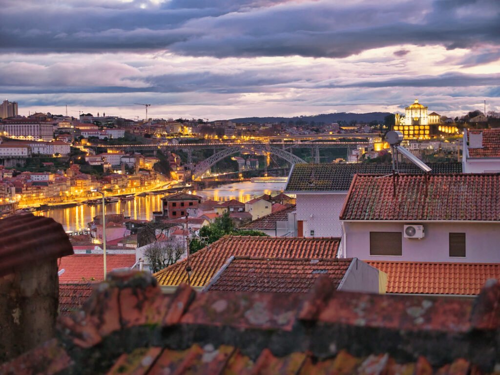 Porto, Portugal: A Slow Travel Guide stormy evening view from my bedroom, ponte luiz & ribeira