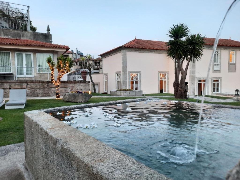 Solo Female Travel in Porto: 3 Day Slow-Travel Itinerary The garden of a restored 18th century historical building with a pool, now serving as a hotel and wellness spa in northern Portugal