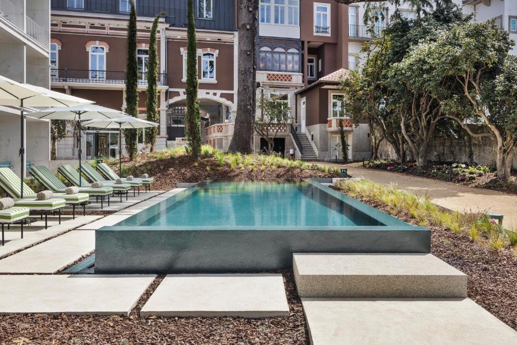 Solo Female Travel in Porto: 3 Day Slow-Travel Itinerary An outdoor swimming pool terrace layout at a boutique hotel resort in northern Portugal.
