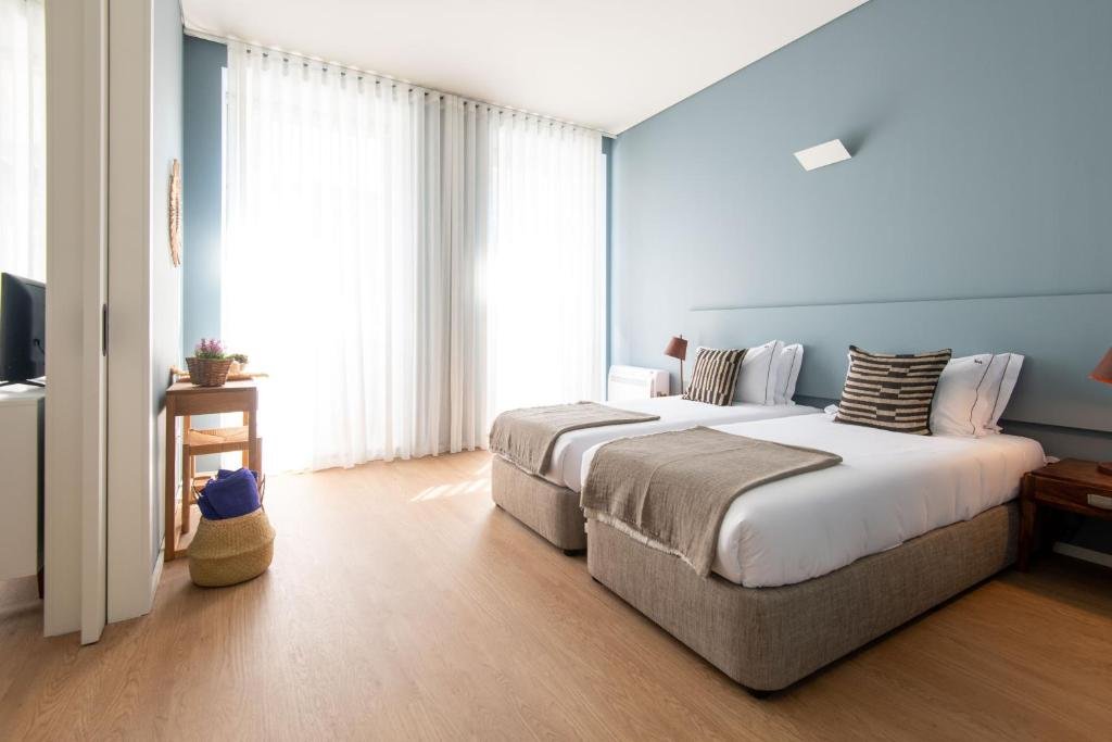 Solo Female Travel in Porto: 3 Day Slow-Travel Itinerary A modern double room bright decorated with soft colors in Porto